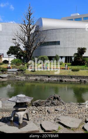 Kyu-Yasuda Garden in Ryogoku district with the building of Japanese Sword Museum in the background, Sumida, Tokyo,Japan Stock Photo