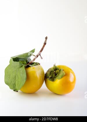 Fresh persimmons on white background Stock Photo