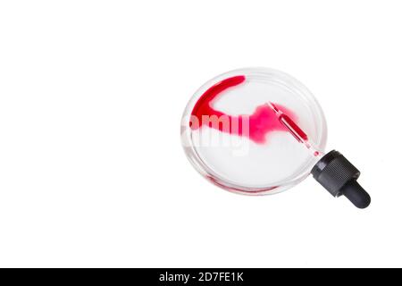 Pandemic blood test, dropper with red liquid in a petri dish Stock Photo
