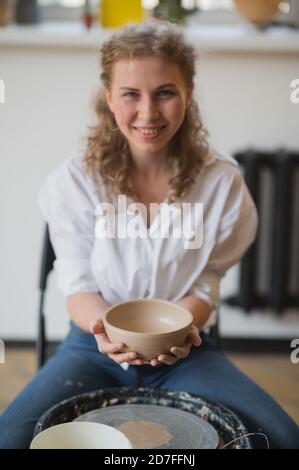 Master class on modeling of clay on a potter wheel In the pottery workshop Stock Photo
