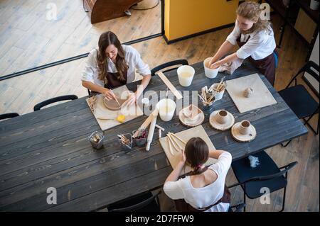 Pottery making from brown clay in ceramic workshop stock photo