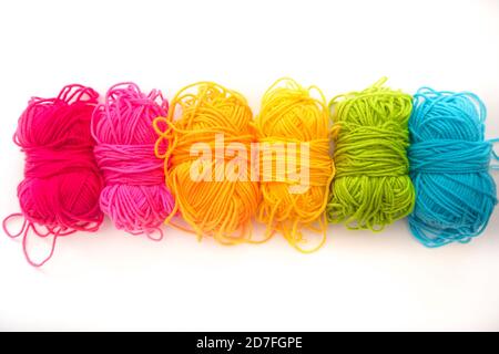 multicolored threads lie on a white background top view Stock Photo