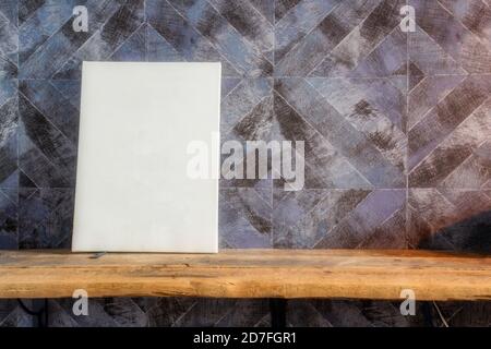 Blank White paper poster on wooden table at diagonal wood plank wall,Template mock up for adding your design and leave space beside frame for adding Stock Photo
