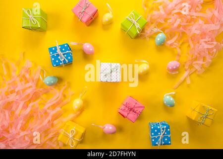 Easter holiday background. Pastel coloured decorated easter eggs on a bright yellow background Stock Photo