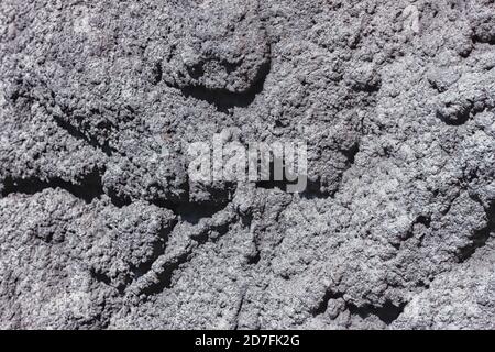 The texture of the plastered wall. Rough corrugated cement surface. Uneven pattern. Suitable for backgrounds and designs. Stock Photo