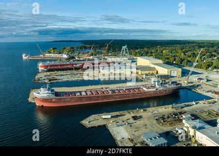 Sturgeon Bay, WI - 4 October 2020:  An aerial view of cargo ships being renovated in a shipyard. Stock Photo