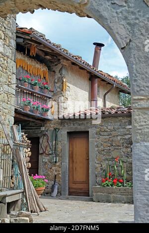 Courtyard of a peasant house in Italy with plants of flowers and panicles hung to be dried. Garfagnana, Tuscany - Italy. Stock Photo