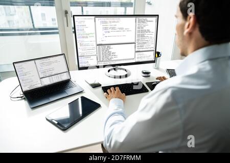 Software Developer Programmer Working On Computer In Office Stock Photo