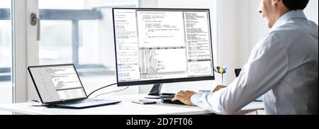 Software Developer Programmer Working On Computer In Office Stock Photo