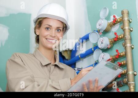 female worker reading water meters Stock Photo