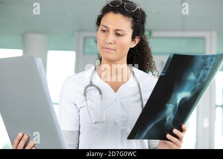 nurse is comparing x-ray results Stock Photo