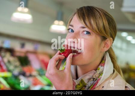 pregnant woman eating strawberries Stock Photo