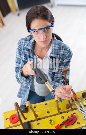 female plumber with pliers and radiator Stock Photo