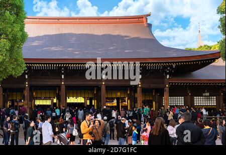 shibuya, japan - november 02 2019: Crowd of tourists in front of the hall of worship or oratory in the Shinto shrine of Meiji-Jingu dedicated to the d