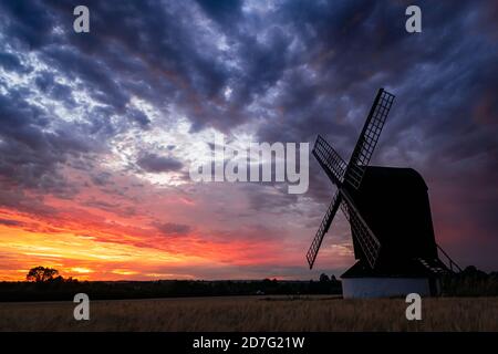 Pitstone, United Kingdom - 31 July 2020: Stunning sunset landscape view for Pitstone Windmill with dramatic cloudy sky and beautiful colors of sun Stock Photo