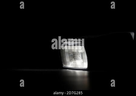Flashlight head on black background in low key light Stock Photo