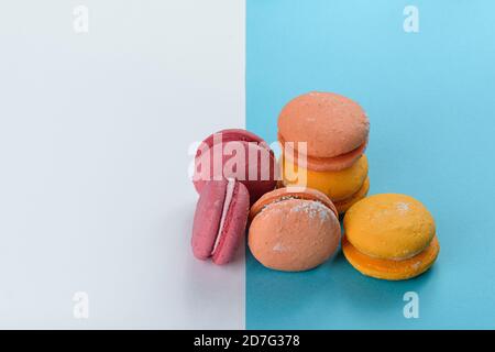 A portion of colorful macaroons on a white and blue background. Stock Photo
