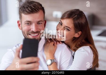 Happy Couple Taking Selfie In Mall Or Office Stock Photo