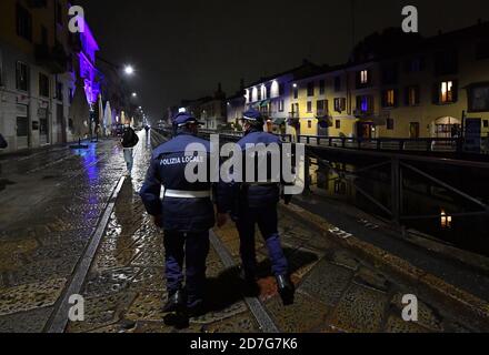 Milan, Italy. 22nd Oct, 2020. Police officers patrol a street amid a spike in new coronavirus infections in Milan, Italy, Oct. 22, 2020. Over 21.7 million Italians, making up over one-third of the country's population, have been placed under curfew amid a spike in new coronavirus infections, which numbered 13,860 on Thursday, officials said. Credit: Daniele Mascolo/Xinhua/Alamy Live News Stock Photo