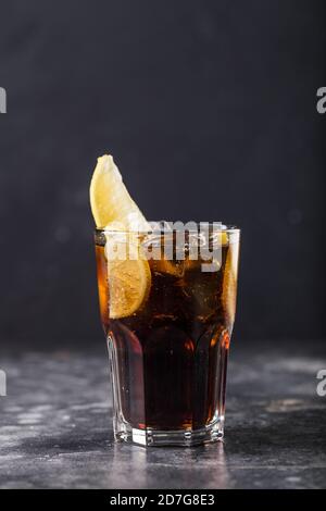 Refreshing alcohol cocktail Long Island Iced Tea in glass placed on table. High quality photo Stock Photo