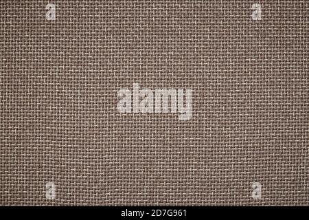 background of rough cloth. textile material in a brown colour. burlap close-up. texture of furniture fabric. Stock Photo