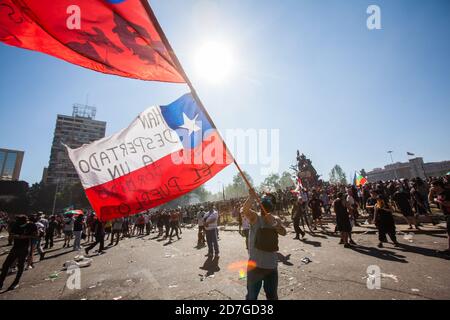 SANTIAGO, CHILE-OCTOBER 18, 2020 - Demonstrator wave Chilean flags during a protest at Plaza Italia in Santiago, Chile Stock Photo
