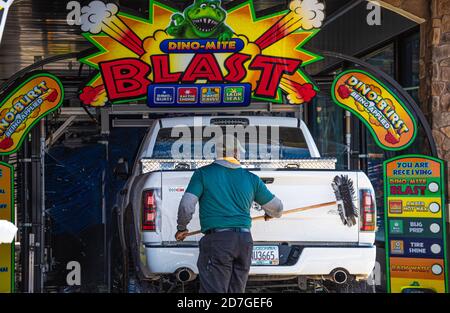 Man pre-wash scrubbing the back of a pickup truck in an automated car wash in Snellville, Georgia. (USA) Stock Photo