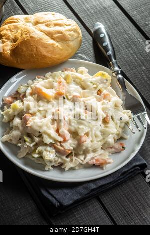 Coleslaw. Salad made of shredded white cabbage and grated carrot with mayonnaise on plate. Stock Photo