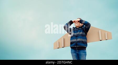 Child playing with toy wings. Business development and promotion Stock Photo