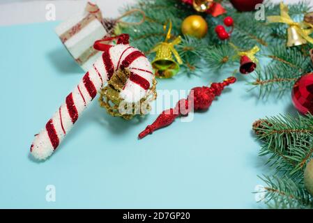 Christmas composition of Christmas toys, candy and spruce branches on a blue background. space for text. Stock Photo