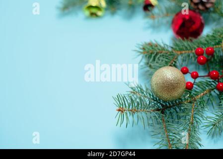 Christmas composition of Christmas toys, candy and spruce branches on a blue background. space for text. Stock Photo
