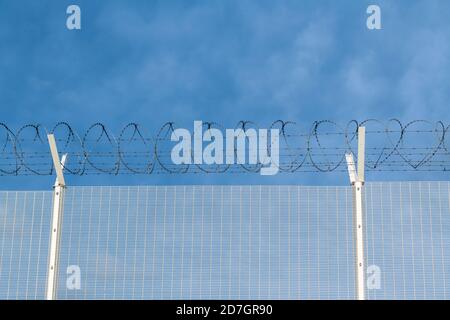 Anti intrusion barbed wire fence Stock Photo
