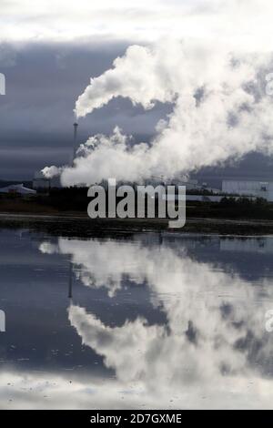 Shewalton, North Ayrshire, Scotland, UK ,Caledonian Paper Mill,  Steam from the mill reflecting in water Stock Photo