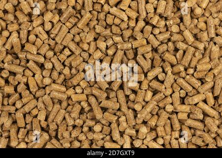 Brown wood pellets texture background. natural pile of wood pellets. organic biofuels. Alternative biofuel from sawdust. The cat litter. pile of compr Stock Photo