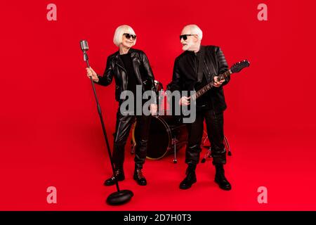 Full length photo two people wife husband retired pensioner rock fan woman singer solo man play bass guitar look enjoy studio tour garage practice Stock Photo