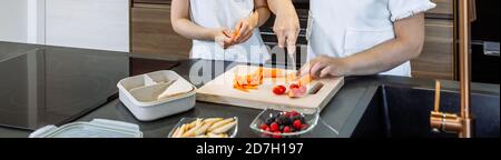 Mother preparing healthy snack for her daughter for school Stock Photo