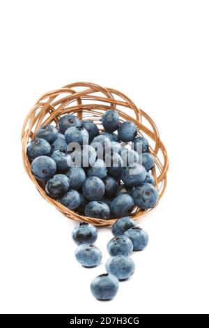 Fresh blueberries in a wicker basket isolated on a white background. Stock Photo