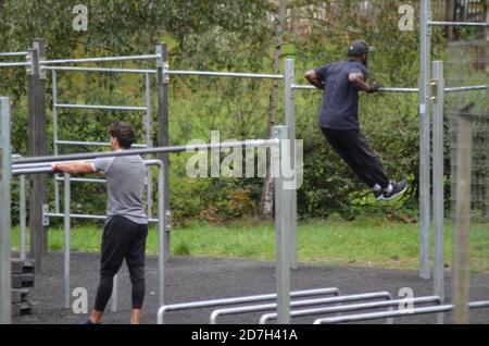 Black Fitness goers on railings Stock Photo - Alamy