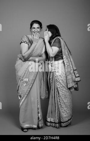 Two mature Indian women gossip with each other Stock Photo - Alamy