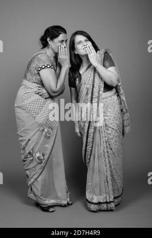 Two mature Indian women gossip with each other Stock Photo - Alamy
