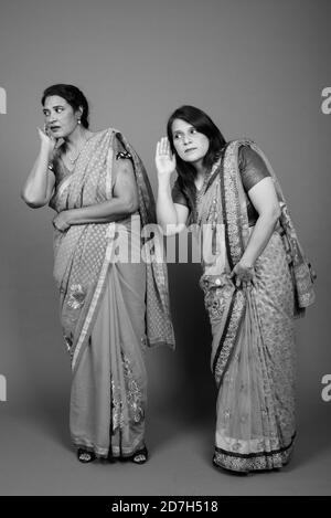 Two mature Indian women gossip with each other Stock Photo - Alamy
