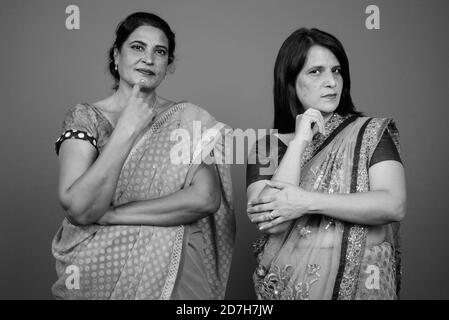 Two mature Indian women wearing Sari Indian traditional clothes together Stock Photo