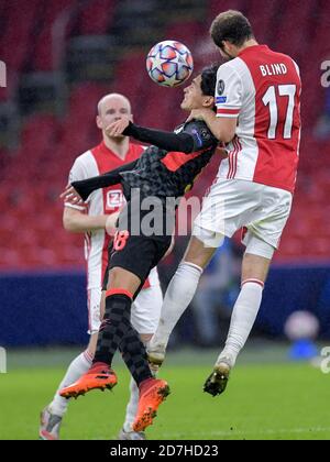 AMSTERDAM, NETHERLANDS - OCTOBER 21: Takumi Minamino of Liverpool FC, Daley Blind of Ajax during the UEFA Champions League match between Ajax and Liverpool at the Johan Cruijff Arena on October 21, 2020 in Amsterdam, Netherlands (Photo by Gerrit van Keulen/Orange Pictures) Stock Photo