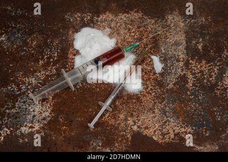 Syringe and drugs on dirty rusty background. Injection syringe. addiction Stock Photo