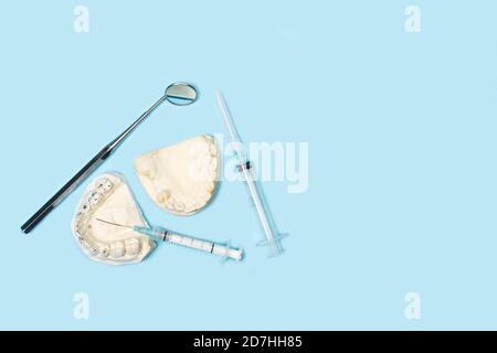 Dentist tools on a light blue background with copy space in a top view Stock Photo