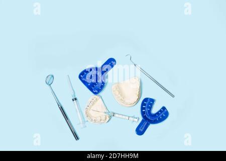 Dentist tools on a light blue background with copy space in a top view Stock Photo