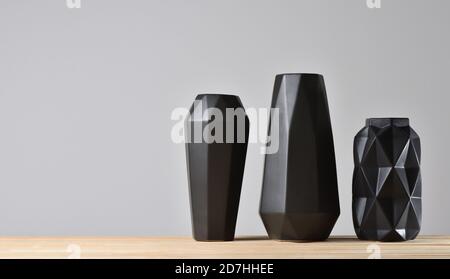 Empty modern black geometric vases on gray background Stock Photo
