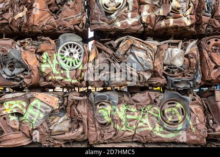 Crushed cars made into building blocks Stock Photo