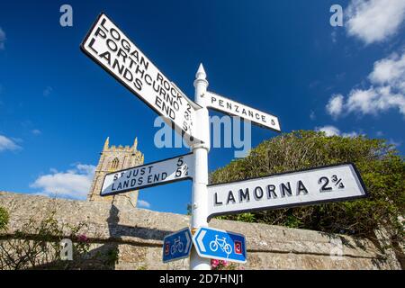 St Buryan church in West Cornwall with a signpost. Stock Photo