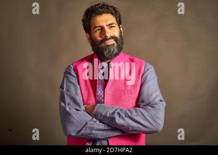 A young Indian man with a typical 'artist' and 'intellectual' look, in a slightly doubtful mood. Stock Photo